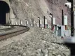 rockfall LiDAR installed next to a railroad track running through a tunnel in a mountainside